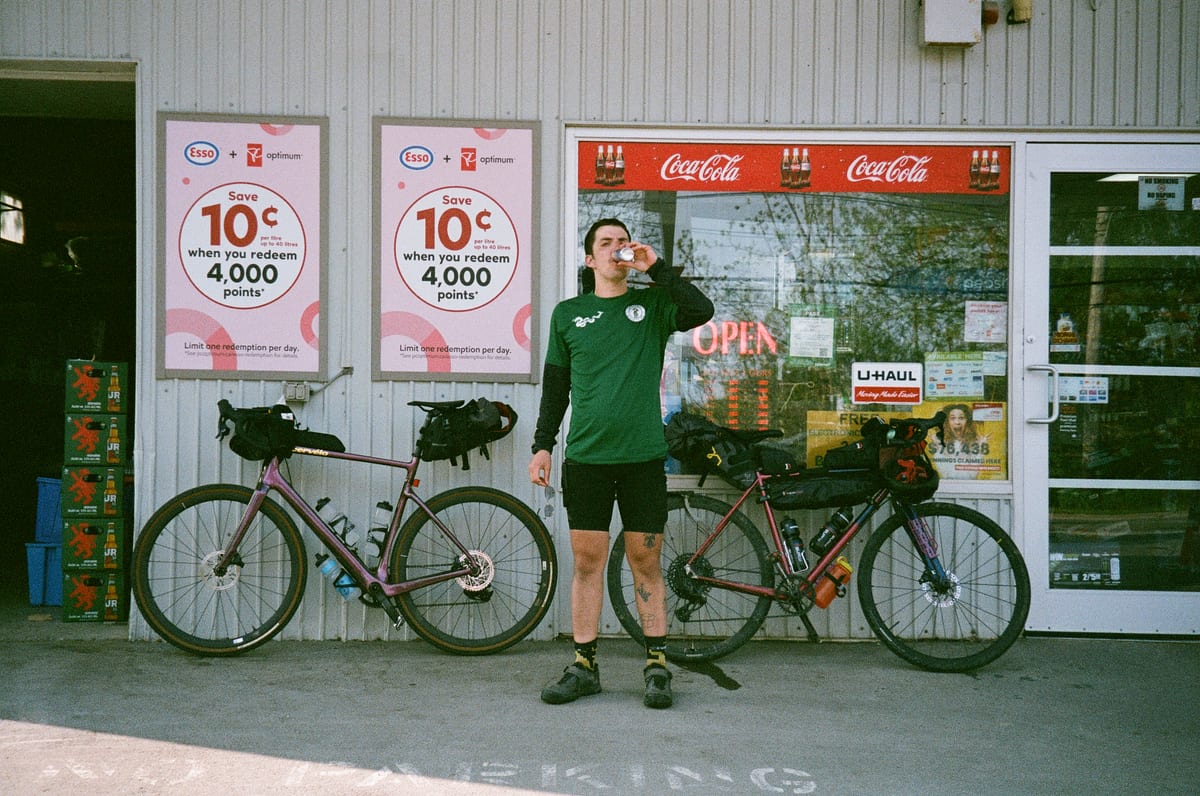 A camp table with touring bikes and trip supplies nearby