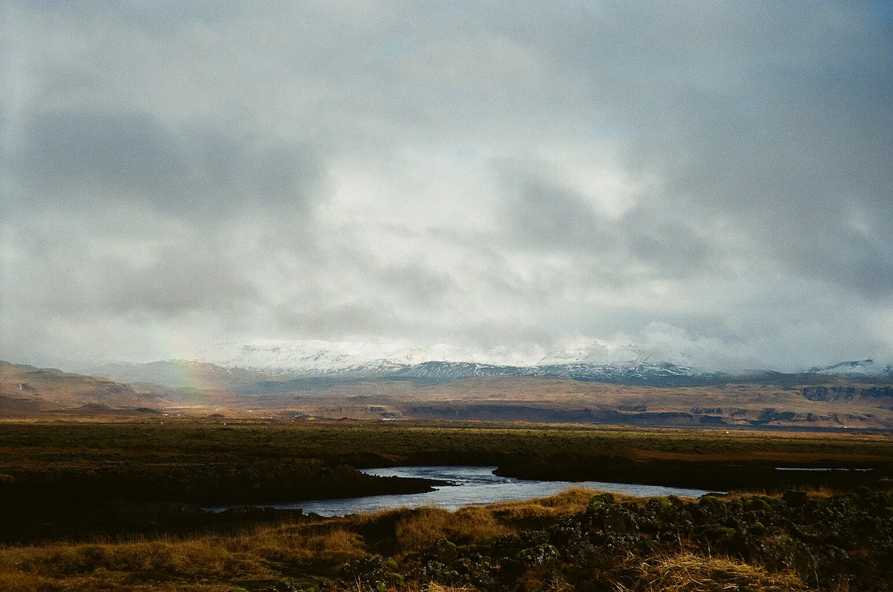 Storm light opening over a wide brown valley