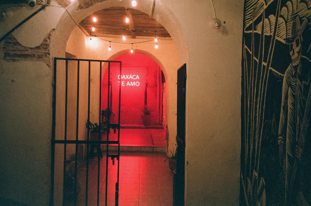 A vivid red doorway glowing at the end of a narrow passage