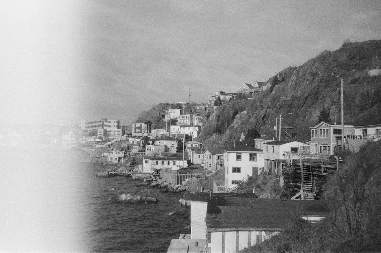 A monochrome hillside village gathered around a narrow harbour