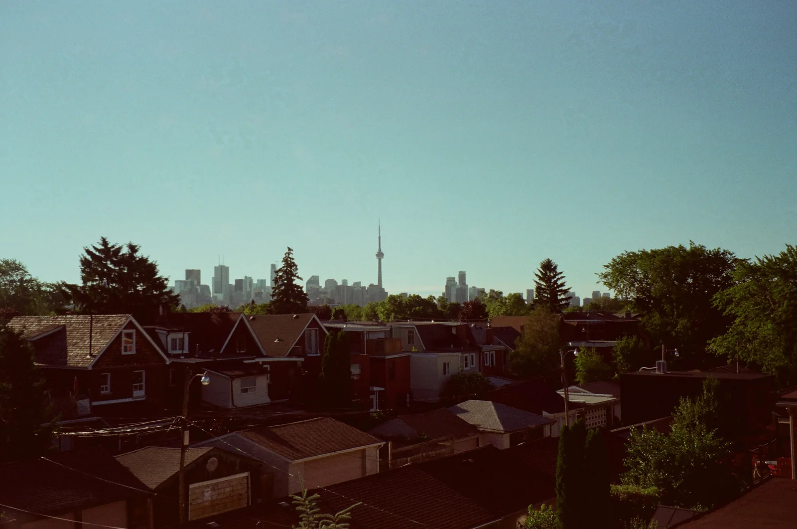 Neighbourhood rooftops and church spires under the last blue light